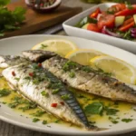 Baked mackerel fillets with lemon and parsley on a plate.