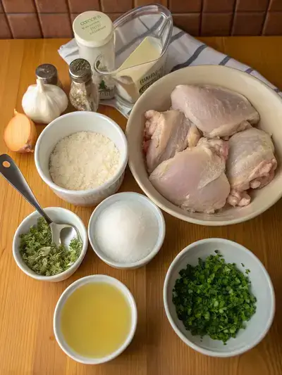 Ingredients for smothered chicken displayed on a kitchen table.