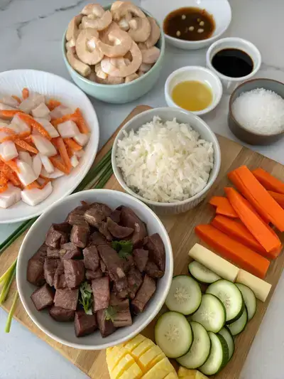 A vibrant assortment of ingredients for homemade hibachi displayed on a kitchen table.