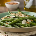 Sautéed green beans with garlic and almonds on a wooden table.