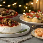 Christmas appetizers table with puff pastry twists, baked brie, stuffed mushrooms, shrimp cocktail and bruschetta