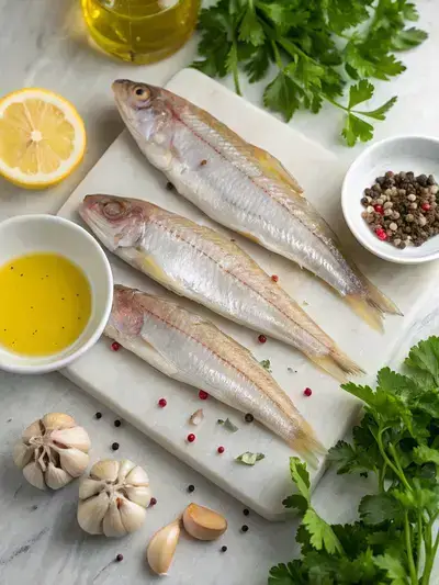Fresh ingredients for whiting fish preparation on a kitchen table.