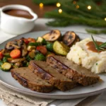 Vegan Christmas recipes dinner plate with mushroom lentil loaf, roasted vegetables, vegan mash and gravy