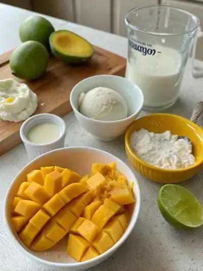 Ingredients for Korean mango ice cream displayed on a kitchen table.
