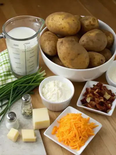 Ingredients for Loaded Mashed Potatoes displayed on a kitchen table.