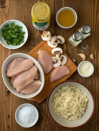 Ingredients for Slow Cooker Chicken Stroganoff displayed on a kitchen table.